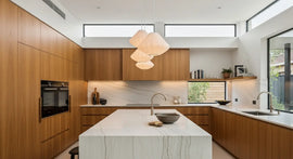Modern Kitchen Design Trends in Perth 2025 – elegant timber cabinetry, stone benchtop, and seamless open-plan layout.