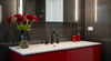 Perth bathroom with premium black tapware and red flowers for a stylish spring upgrade.