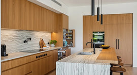 Modern Perth kitchen showcasing 2025 trends with natural timber, stone benchtops, smart storage, and multifunctional island.